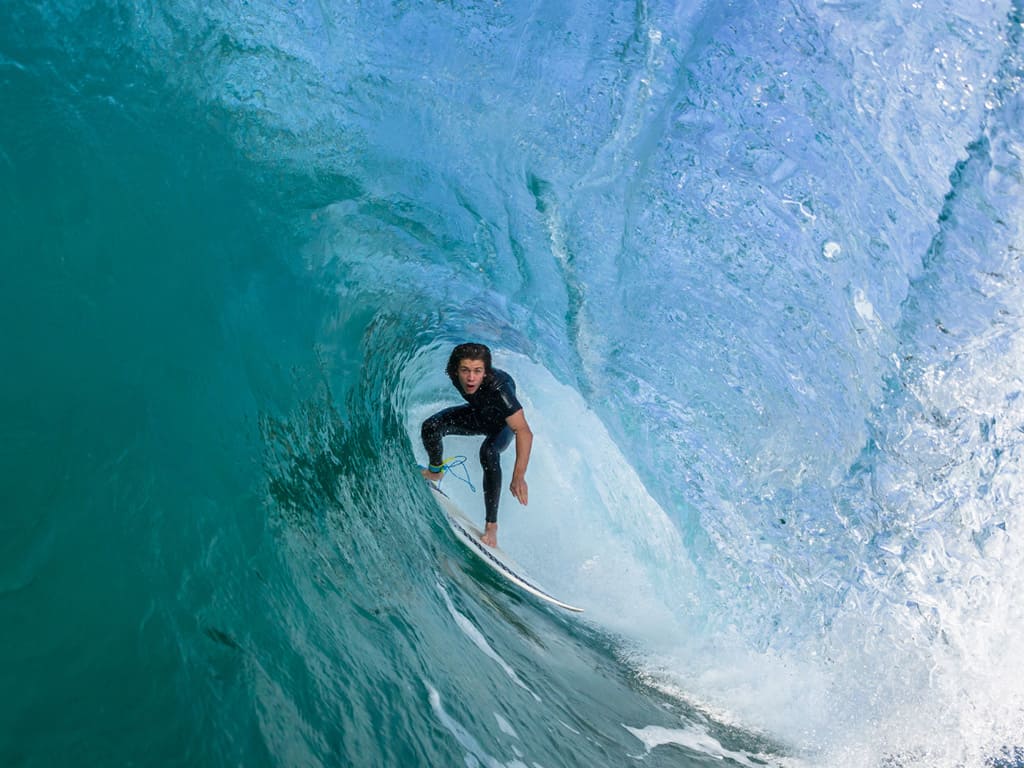 Surfer riding a clean wave in Playa Guiones, Nosara Costa Rica