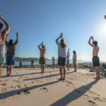 Practitioners performing Taijiquan outdoors at sunrise, representing both International Taijiquan Day on March 21 and World Tai Chi and Qigong Day on the last Saturday of Apri
